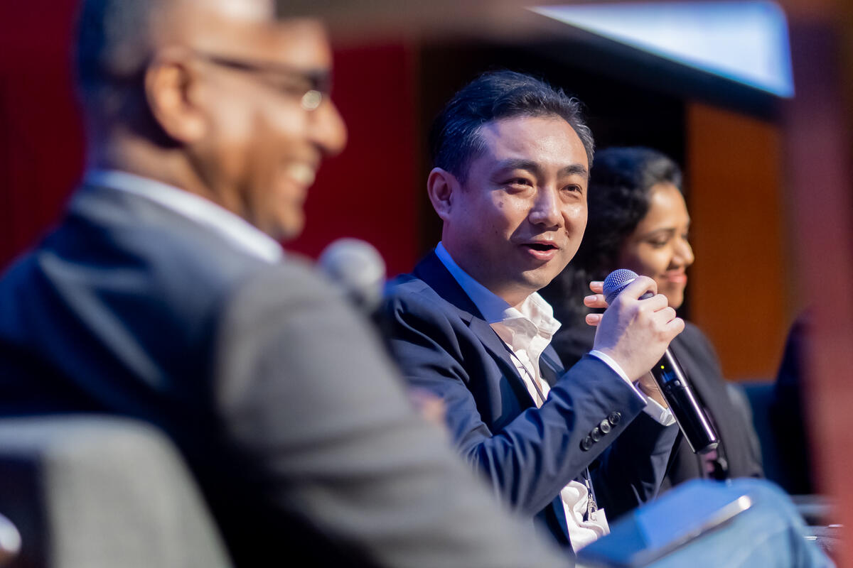 A panellist speaking into a microphone